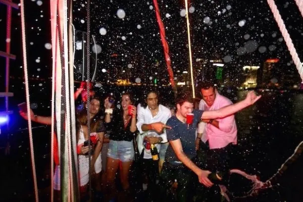 a young man holding a swing at night