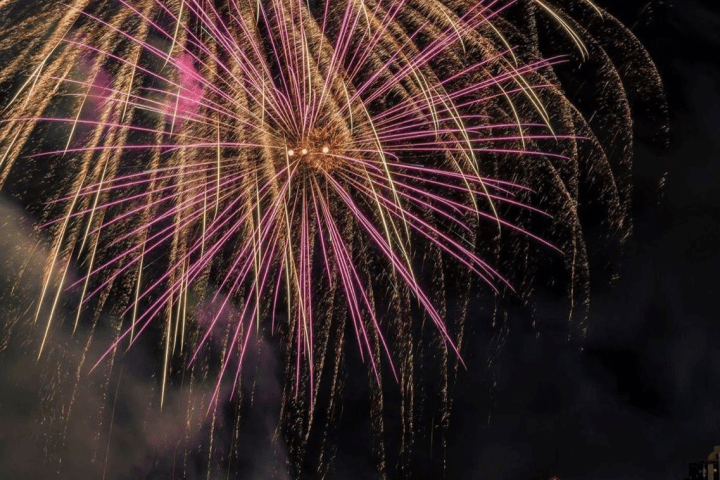 fireworks in the night sky over a body of water