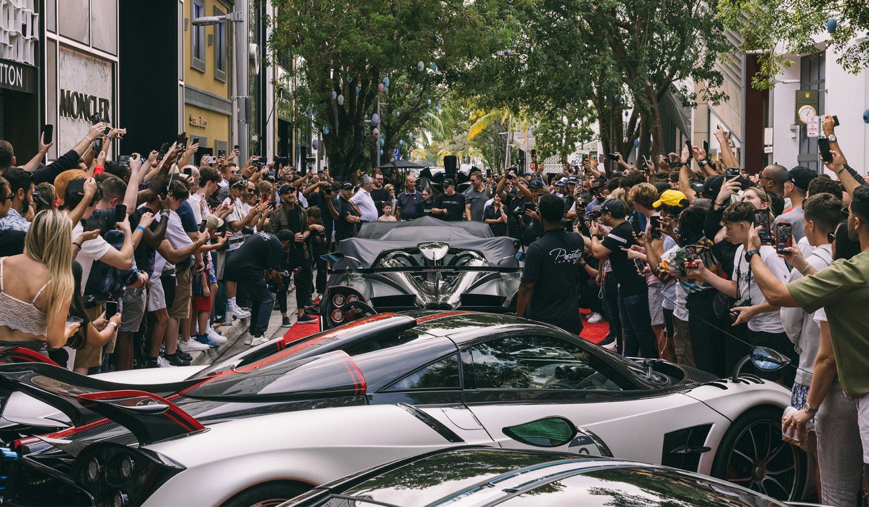 a group of people on a motorcycle in front of a crowd