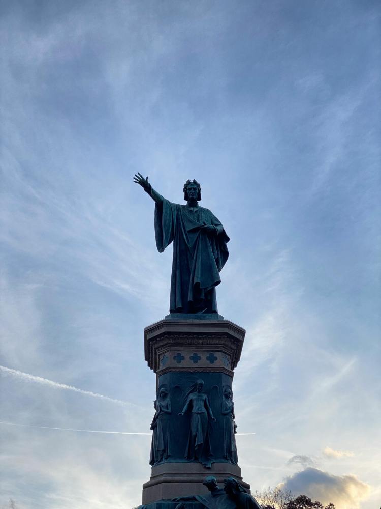 a tall clock tower with a statue of a person