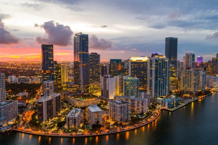 a bridge over a body of water with a city in the background