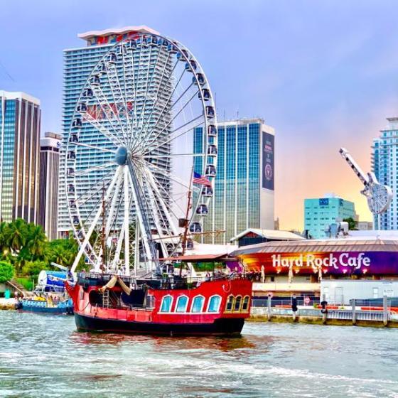 a large ship in the water with a city in the background