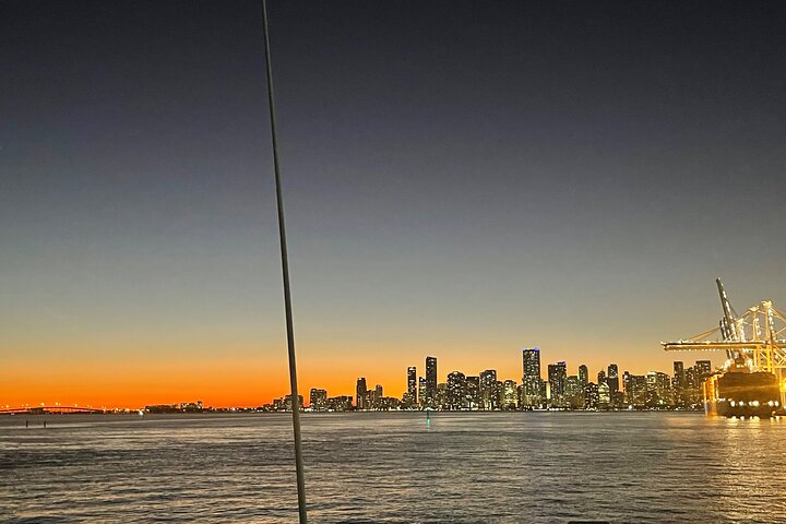 a sunset over a body of water with a city in the background