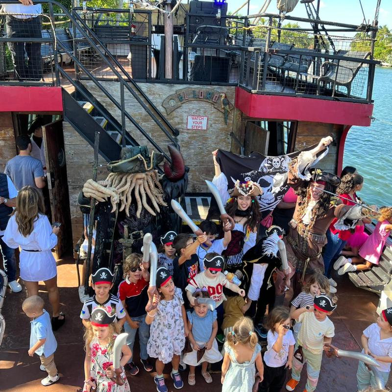 a group of people standing next to a body of water