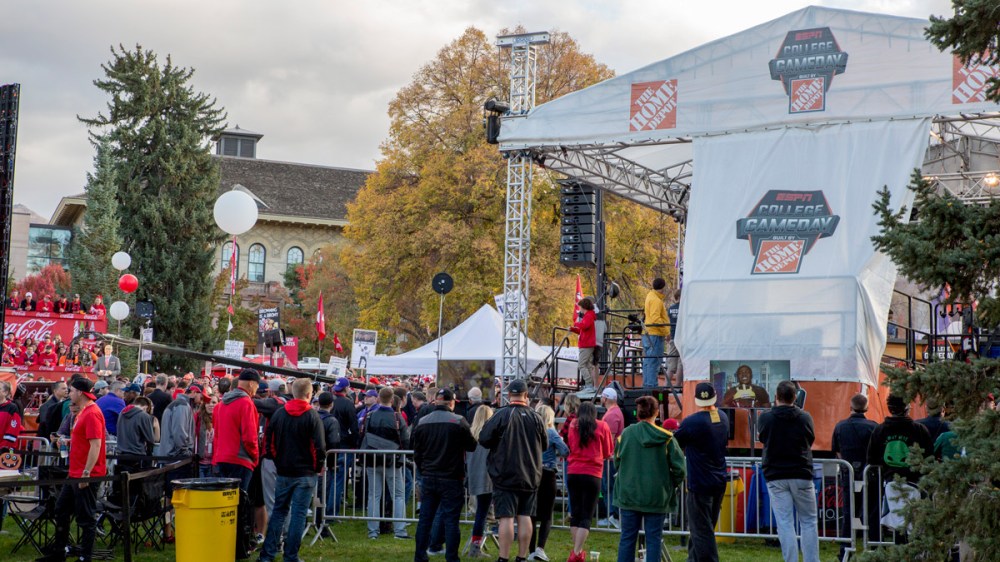 Crowd gathered at an outdoor event with large ESPN College GameDay setup and banners.