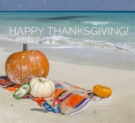 Pumpkins on a colorful blanket at a beach with 'Happy Thanksgiving!' written above.